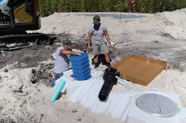 Technician Installing a 950-Gallon Norwesco ATU Unit Technician Installing a 950-Gallon Norwesco ATU Unit