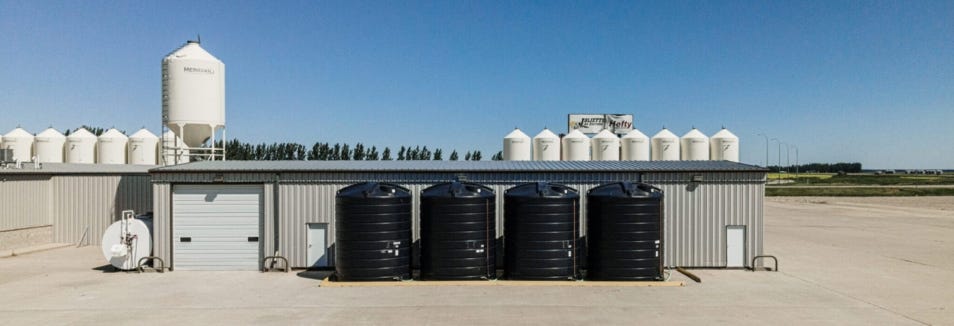 Multiple water storage tanks installed outside an industrial building Multiple water storage tanks installed outside an industrial building