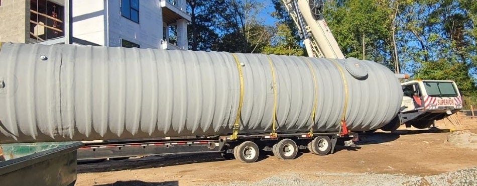 Massive underground fiberglass tank offloaded at a residential facility. Massive underground fiberglass tank offloaded at a residential facility.
