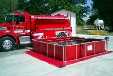 Folding frame water tank set up beside a fire truck for emergency water storage Folding frame water tank set up beside a fire truck for emergency water storage
