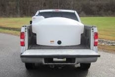 Pickup truck with a mounted water storage tank in the truck bed Pickup truck with a mounted water storage tank in the truck bed