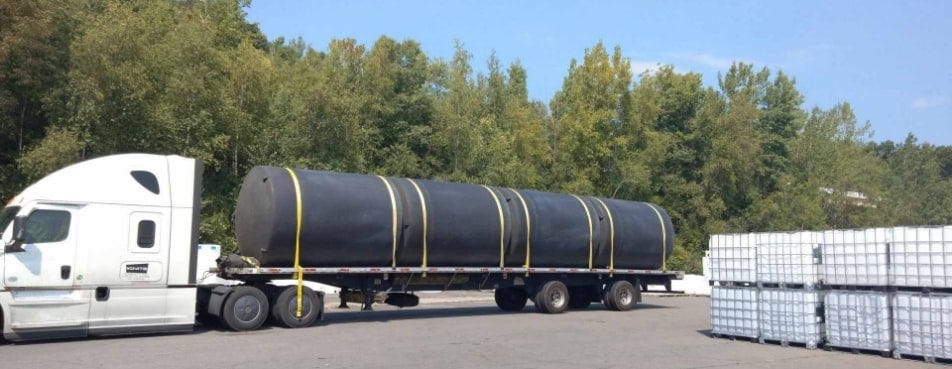 18-wheeler ready to transport 5000 gallon water storage tanks from a Tank Depot site. 18-wheeler ready to transport 5000 gallon water storage tanks from a Tank Depot site.