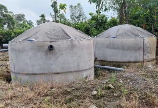 Two dome-shaped water storage tanks installed outdoors for agricultural or irrigation use. Two dome-shaped water storage tanks installed outdoors for agricultural or irrigation use.