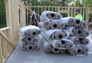 Stacks of EZflow drainage bundles stored at a residential construction site for septic or drainage system repairs. Stacks of EZflow drainage bundles stored at a residential construction site for septic or drainage system repairs.