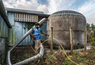 Worker with piping system connected to water tank. Worker with piping system connected to water tank.