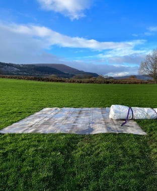 Foundation liner laid out on grass with rolled tank material ready for installation. Foundation liner laid out on grass with rolled tank material ready for installation.