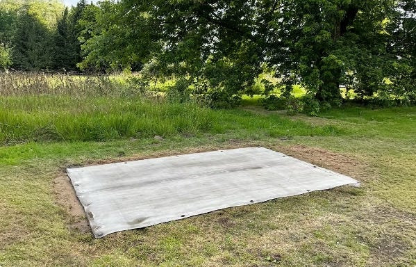 Rectangular flexible foundation slab installed on grass, prepared as a base for a water storage tank. Rectangular flexible foundation slab installed on grass, prepared as a base for a water storage tank.