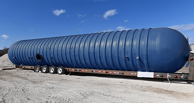 Underground fiberglass tank is being delivered to a job site. Underground fiberglass tank is being delivered to a job site.