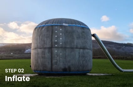 Inflated concrete Omni Tank standing on an Instaslab foundation mat during Step 02 of installation, with an air hose connected on one side. Inflated concrete Omni Tank standing on an Instaslab foundation mat during Step 02 of installation, with an air hose connected on one side.