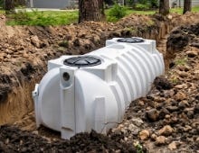 White advanced treatment unit tank placed in an excavated trench for underground septic system installation. White advanced treatment unit tank placed in an excavated trench for underground septic system installation.
